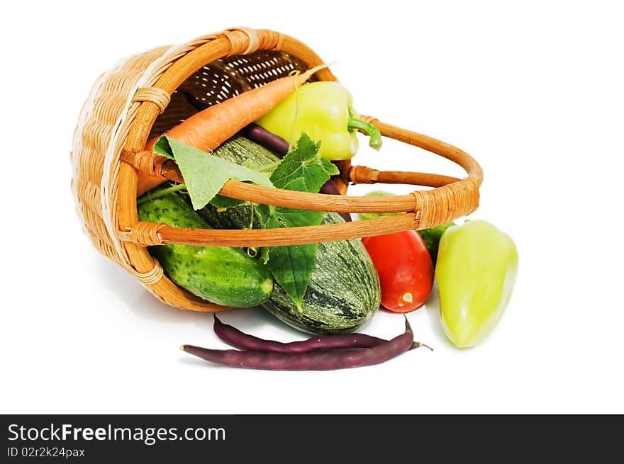 Wattled basket with vegetables isolated on white