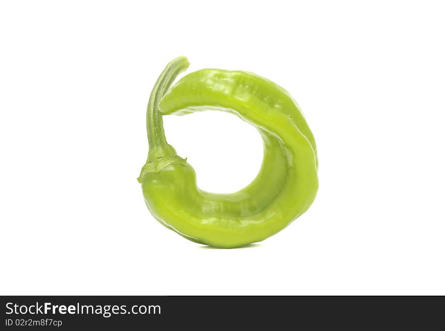 A green hot chili pepper isolated on a white background. A green hot chili pepper isolated on a white background