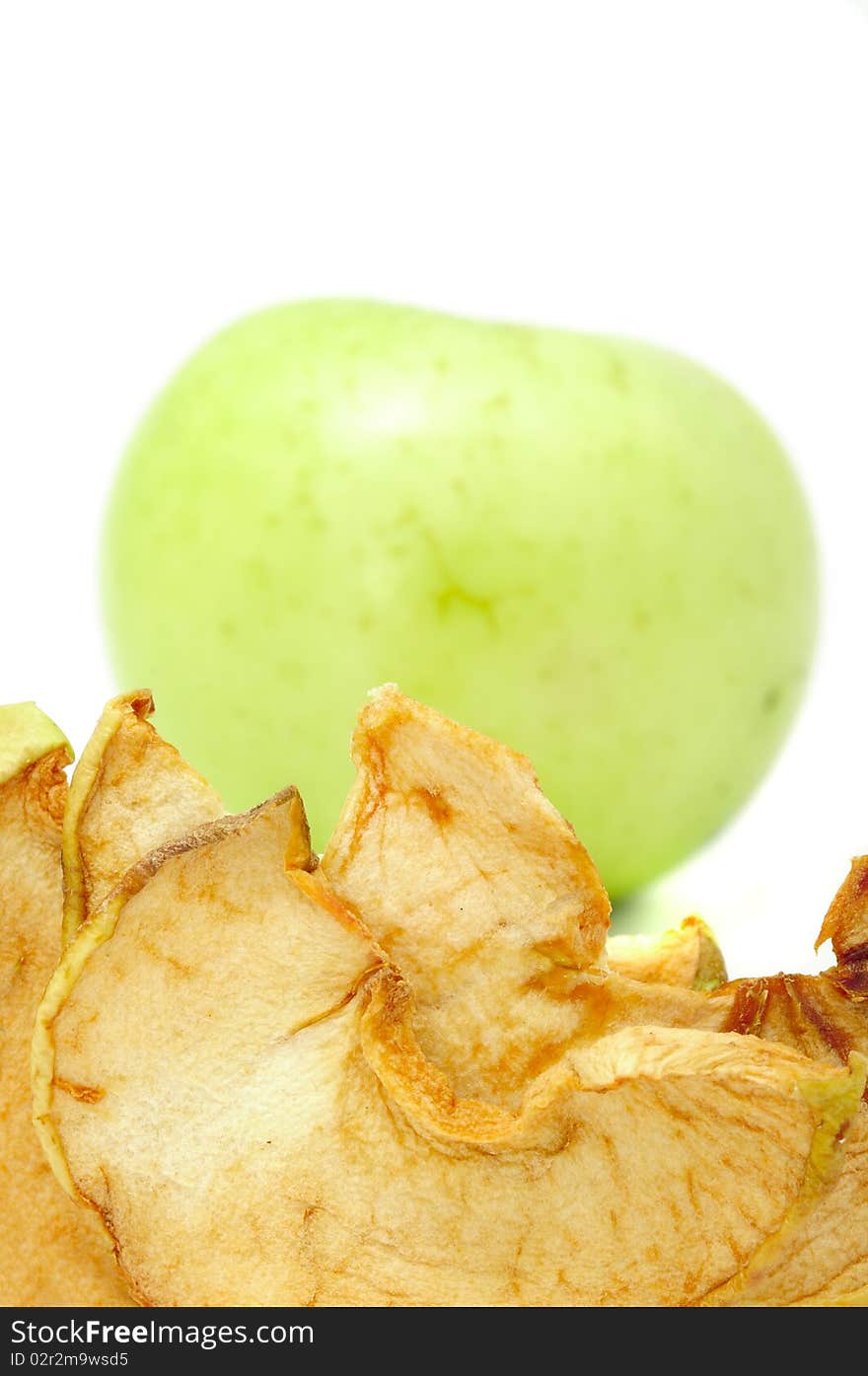 Dried aplles with a fresh green apple in the background. Dried aplles with a fresh green apple in the background