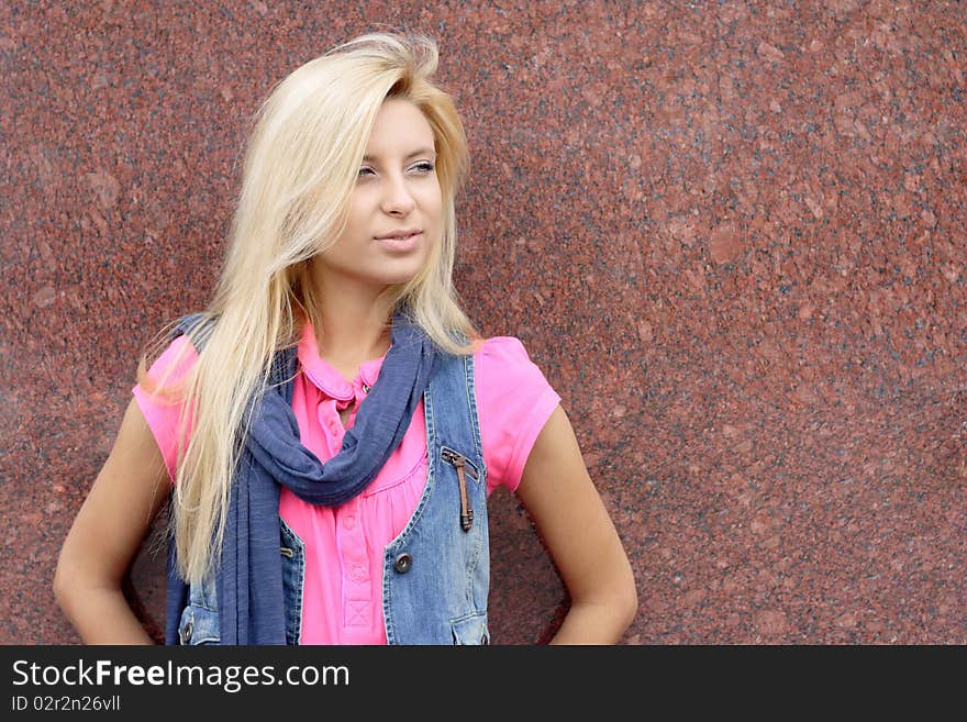 Portrait of the young woman on a background of a wall