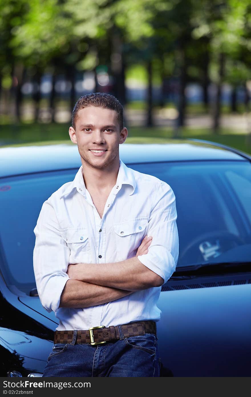 Attractive young man standing by car. Attractive young man standing by car