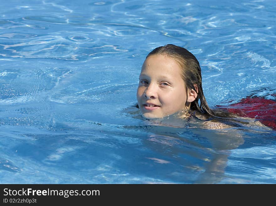 Young girl swimming in pool