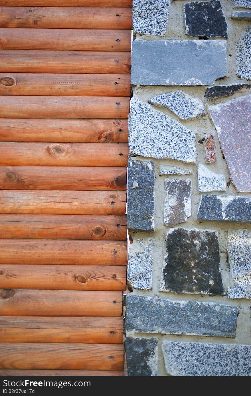 Wall from wood and stones in the interior