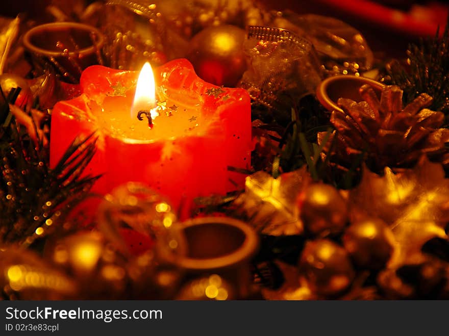 Red new year burning candle in gold decoration background. Red new year burning candle in gold decoration background