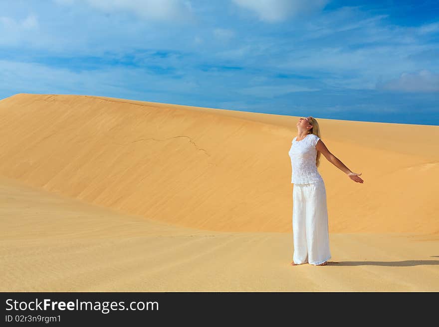 Beautiful woman with opened nahds in desert. Beautiful woman with opened nahds in desert