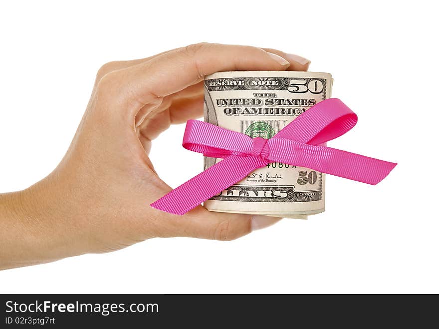 Hand holding bundle of dollars tied in a bow isolated on white. Hand holding bundle of dollars tied in a bow isolated on white