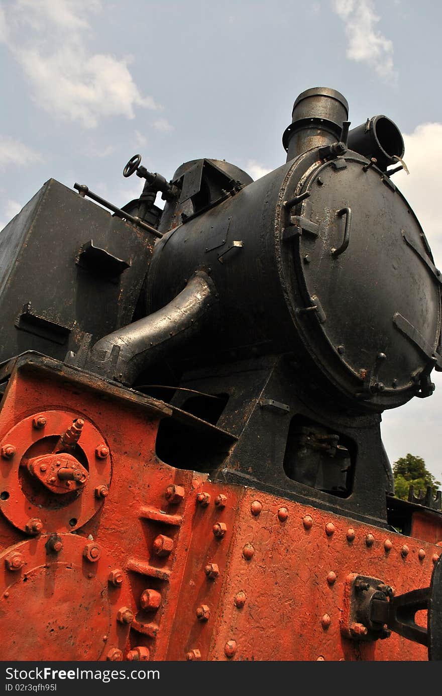 Front of a old locomotive transformed into a monument