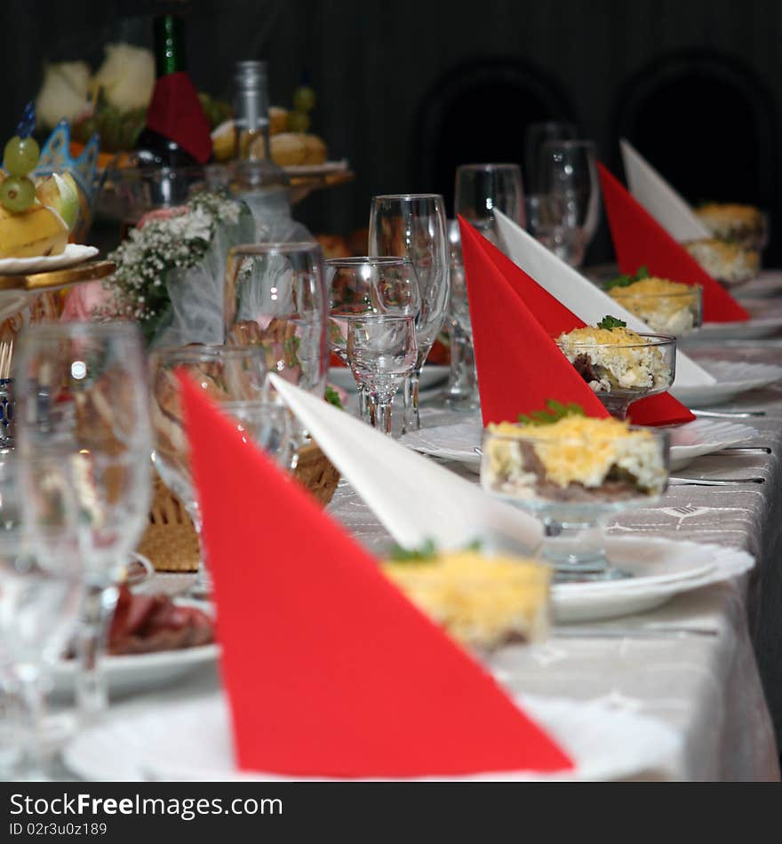 Festively covered table with red and white napkins. Festively covered table with red and white napkins