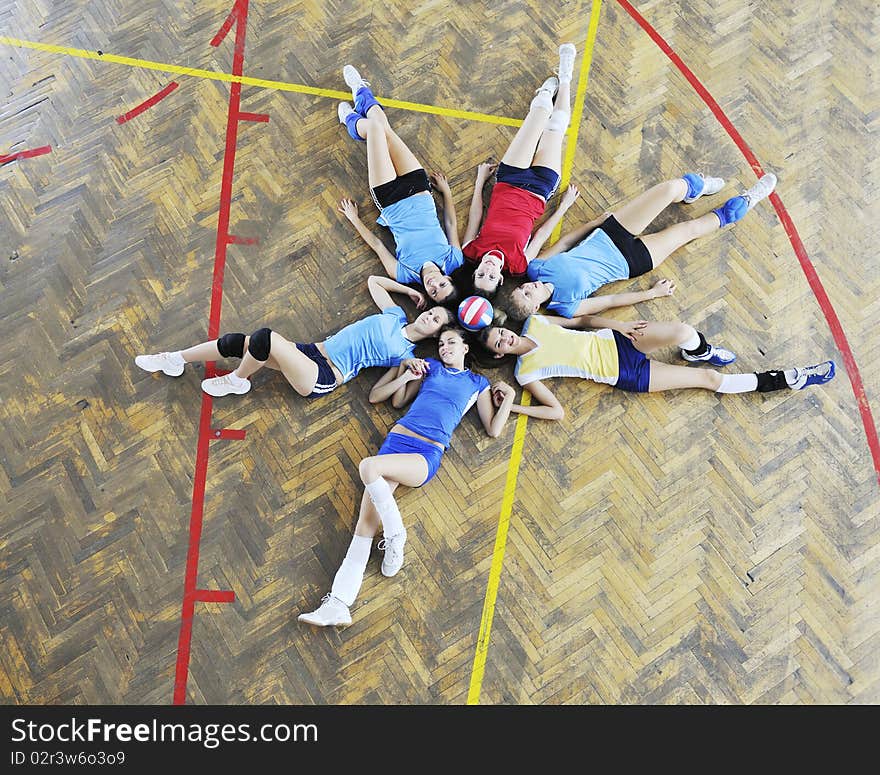 Girls playing volleyball indoor game