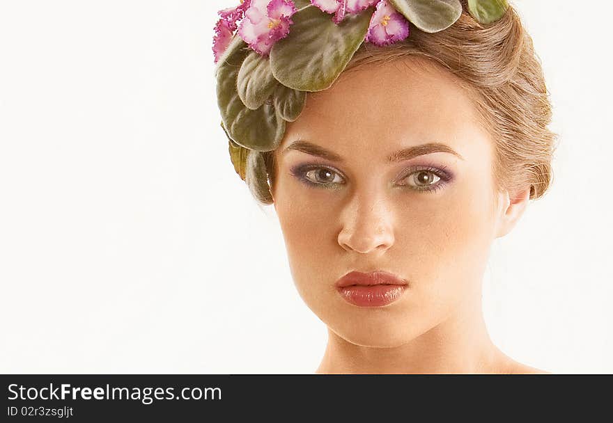 Beautiful girl with a wreath of flowers