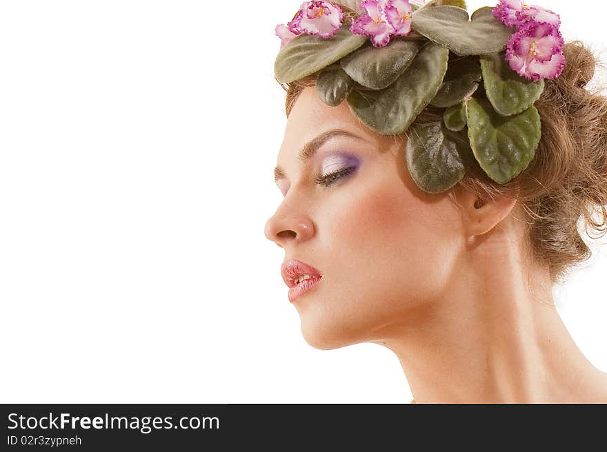 Portrait of beautiful girl with a wreath of flowers on her head