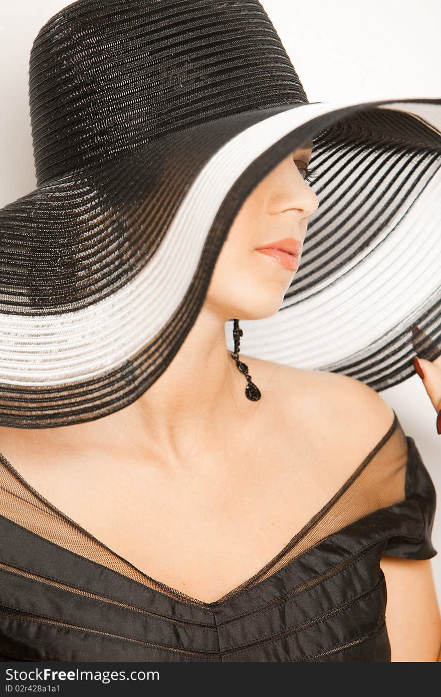 Fashion Girl In A Big Hat In The Studio