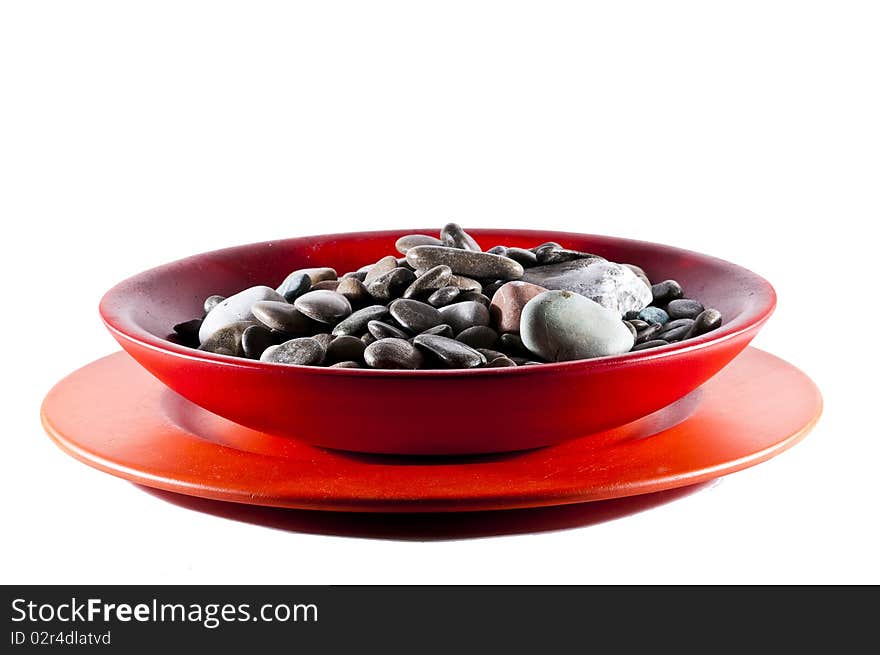 Stylish wooden plate full of pebble