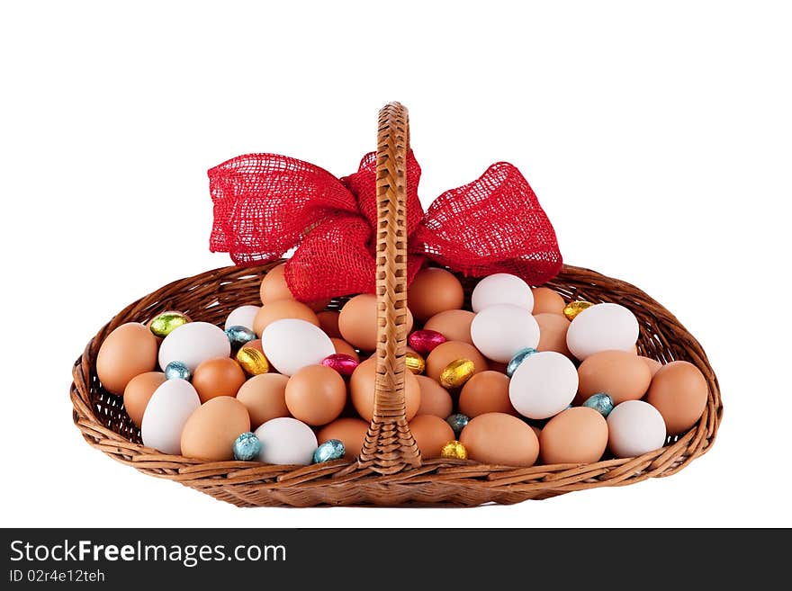 Easter Hens eggs in a basket with red Ribbon isolated on white. Easter Hens eggs in a basket with red Ribbon isolated on white