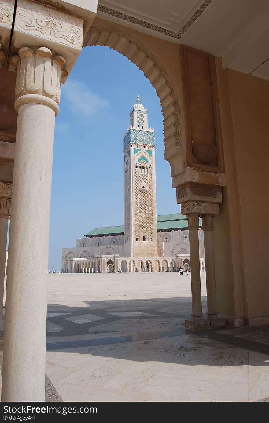 The towering minaret at Hassan II mosque in Casablanca is seen through an arch in the forecourt. The towering minaret at Hassan II mosque in Casablanca is seen through an arch in the forecourt