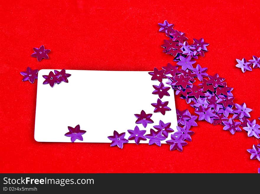 White card and violet stars on red background