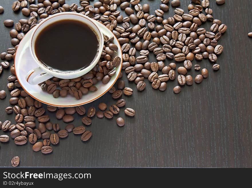 A cup of coffee on coffee beans background