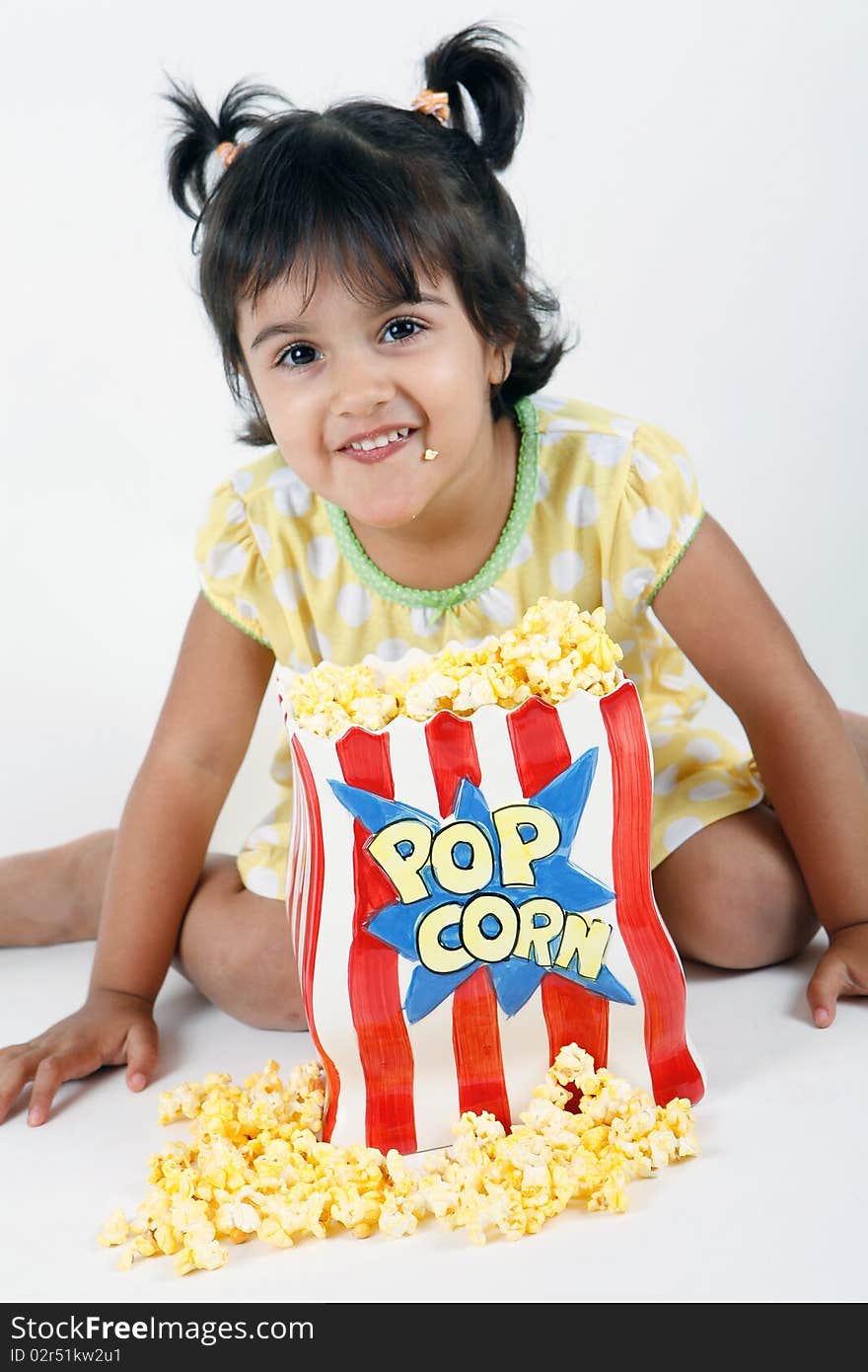 Sweet and cute toddler eating and enjoying pop corn. Sweet and cute toddler eating and enjoying pop corn