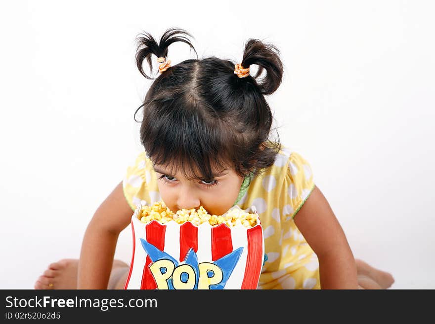 Sweet and cute toddler eating and enjoying pop corn. Sweet and cute toddler eating and enjoying pop corn