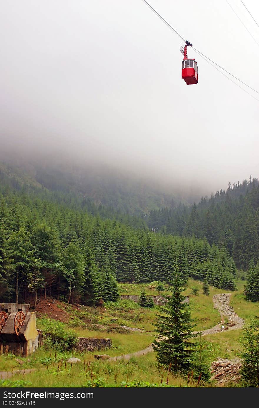 Cable car at high altitude in fog mountains