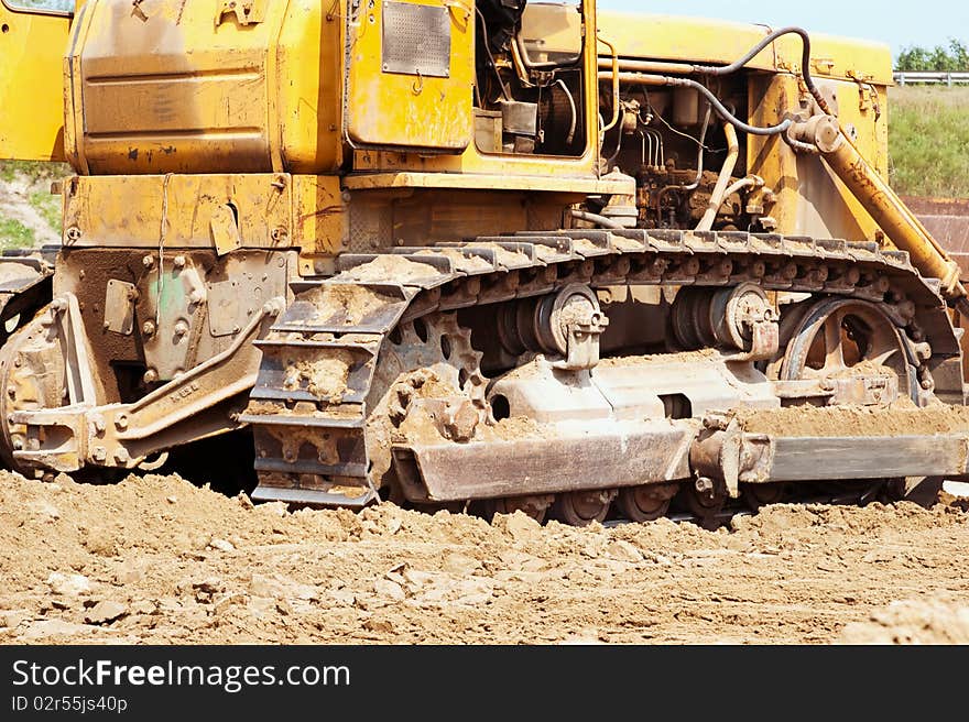 Bulldozer treads creap past at an urban sprawl construction site.PLEASE EMAIL ME to let me know how you used my photograph. I would appreciate it very much!! THANKS. I appreciate your feedback! Please rate this image if you download it.