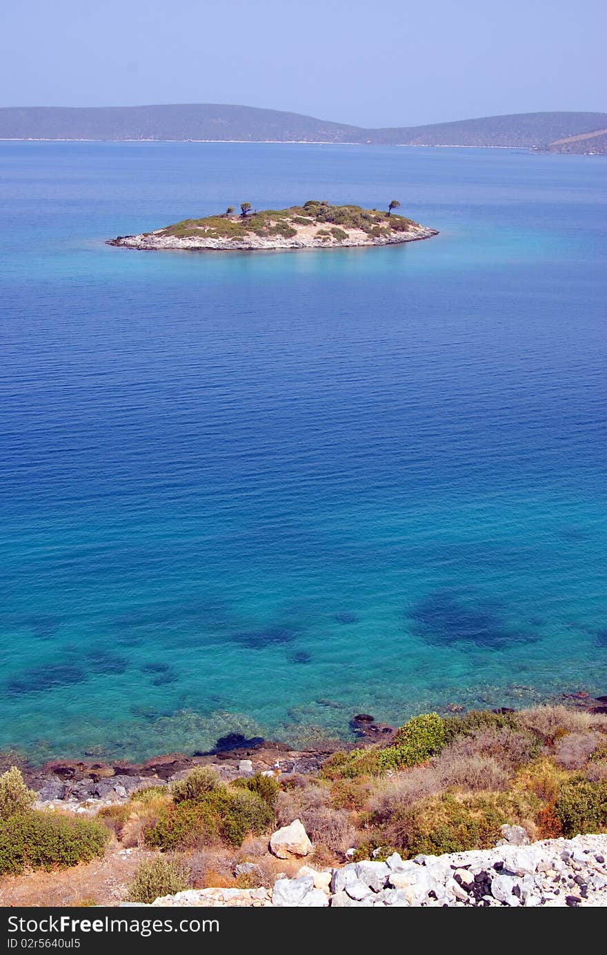 Beautiful landscape with island in quiet blue sea. Beautiful landscape with island in quiet blue sea