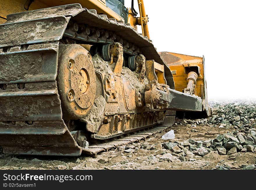 Dirty yellow tractor on tracks major planm. Dirty yellow tractor on tracks major planm