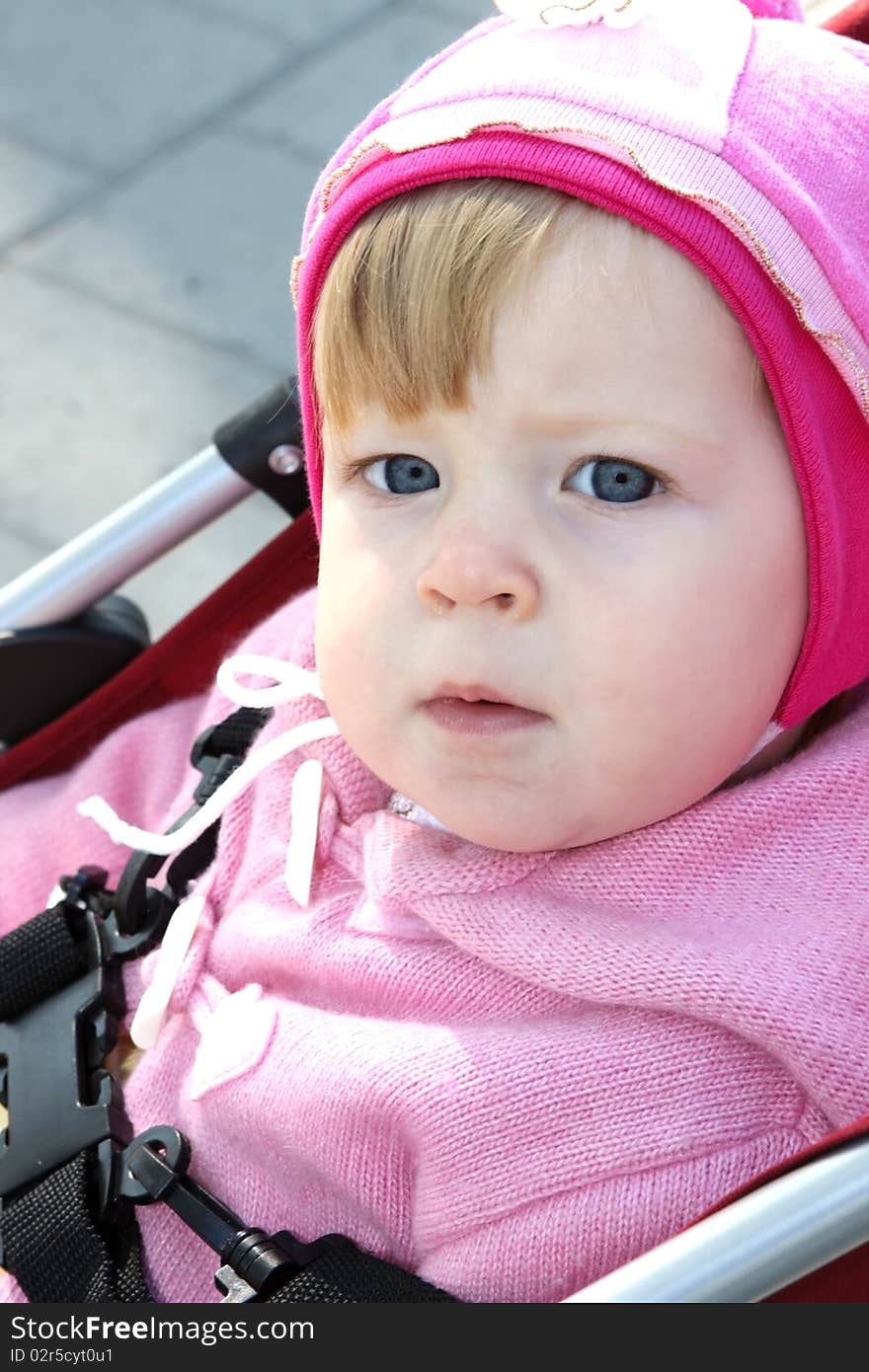 A serious little girl with blue eyes. A serious little girl with blue eyes