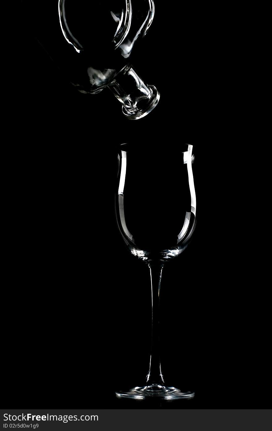 Bottle and glass on a black background