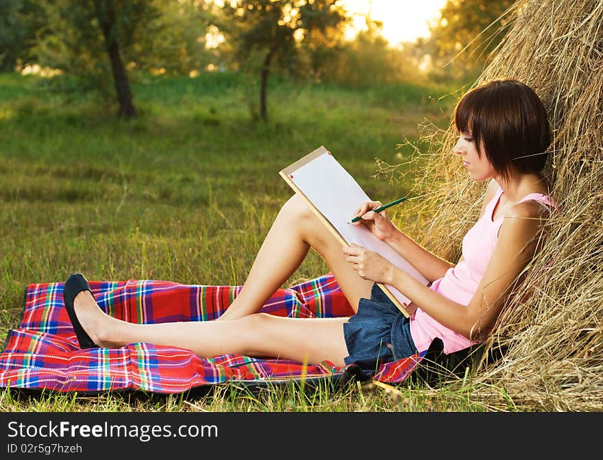 Lovely girl drawing in the park