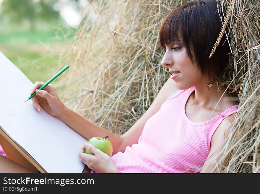 Lovely girl drawing in the park