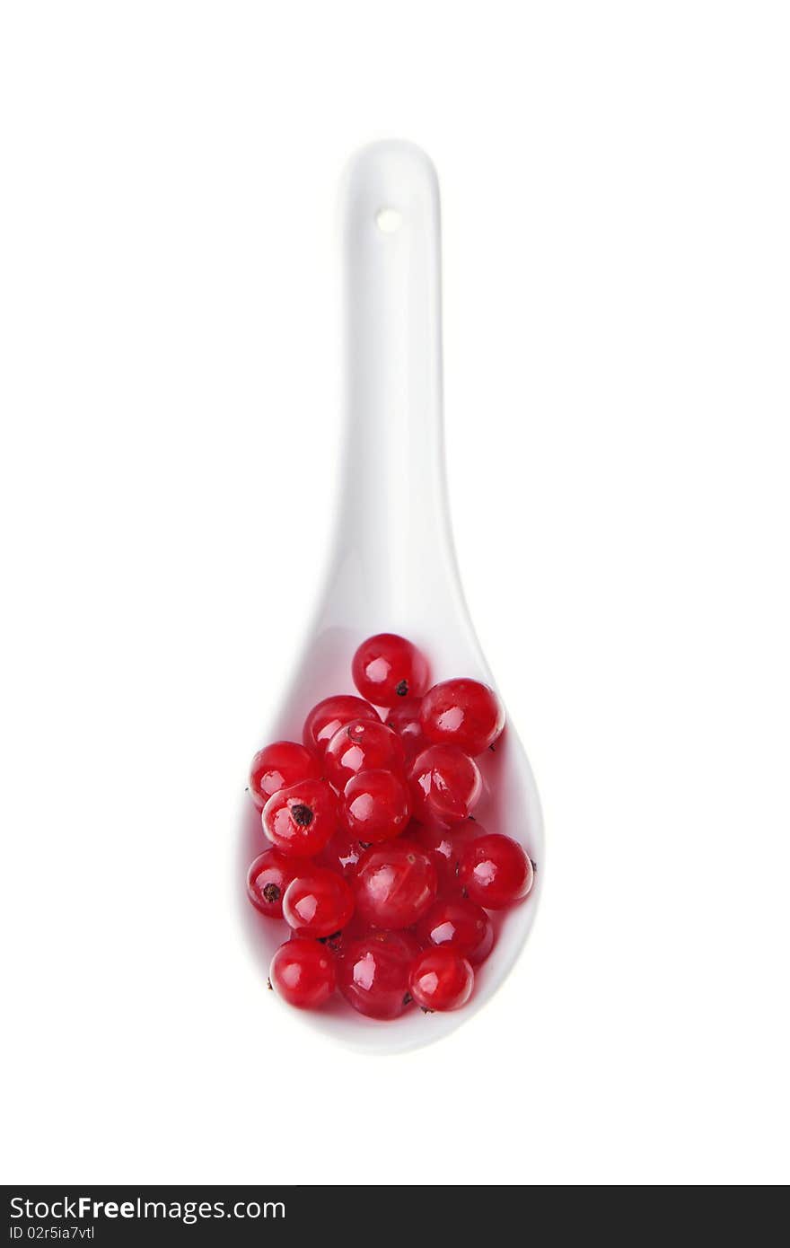 Currants in spoon against white background, close-up. Currants in spoon against white background, close-up