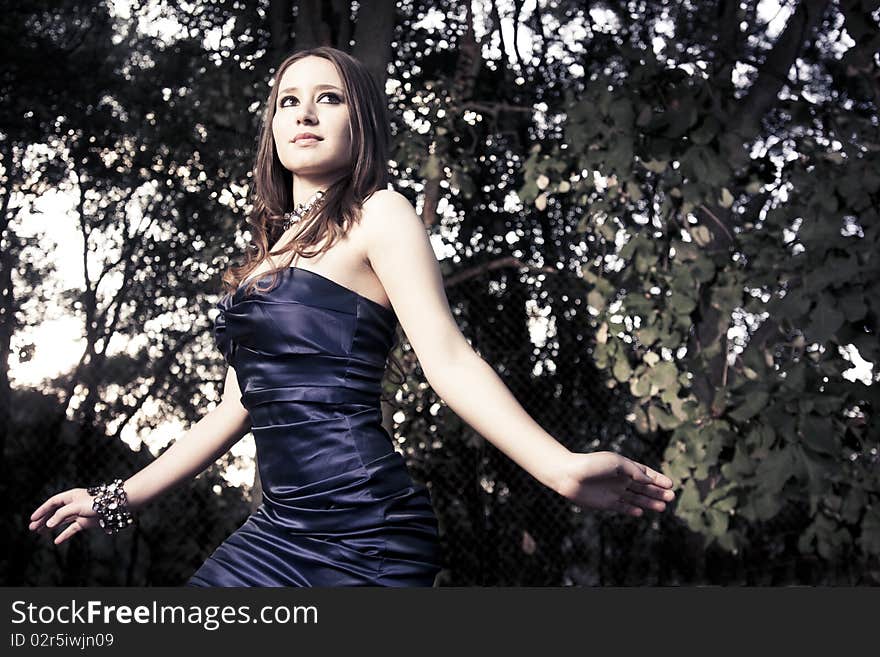 Fashion photo of beautiful woman walking in woods