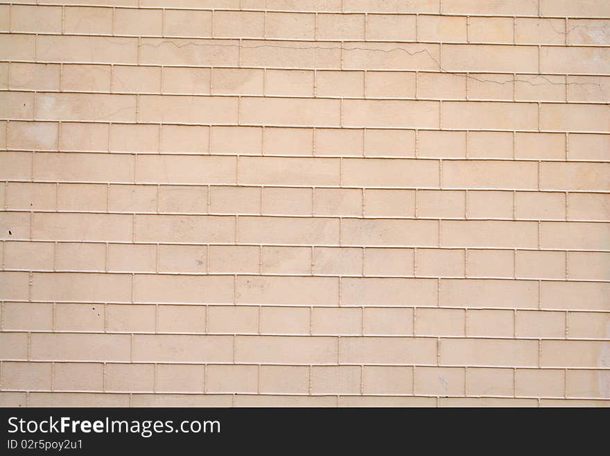 Part of a wall made of brick and covered with paint