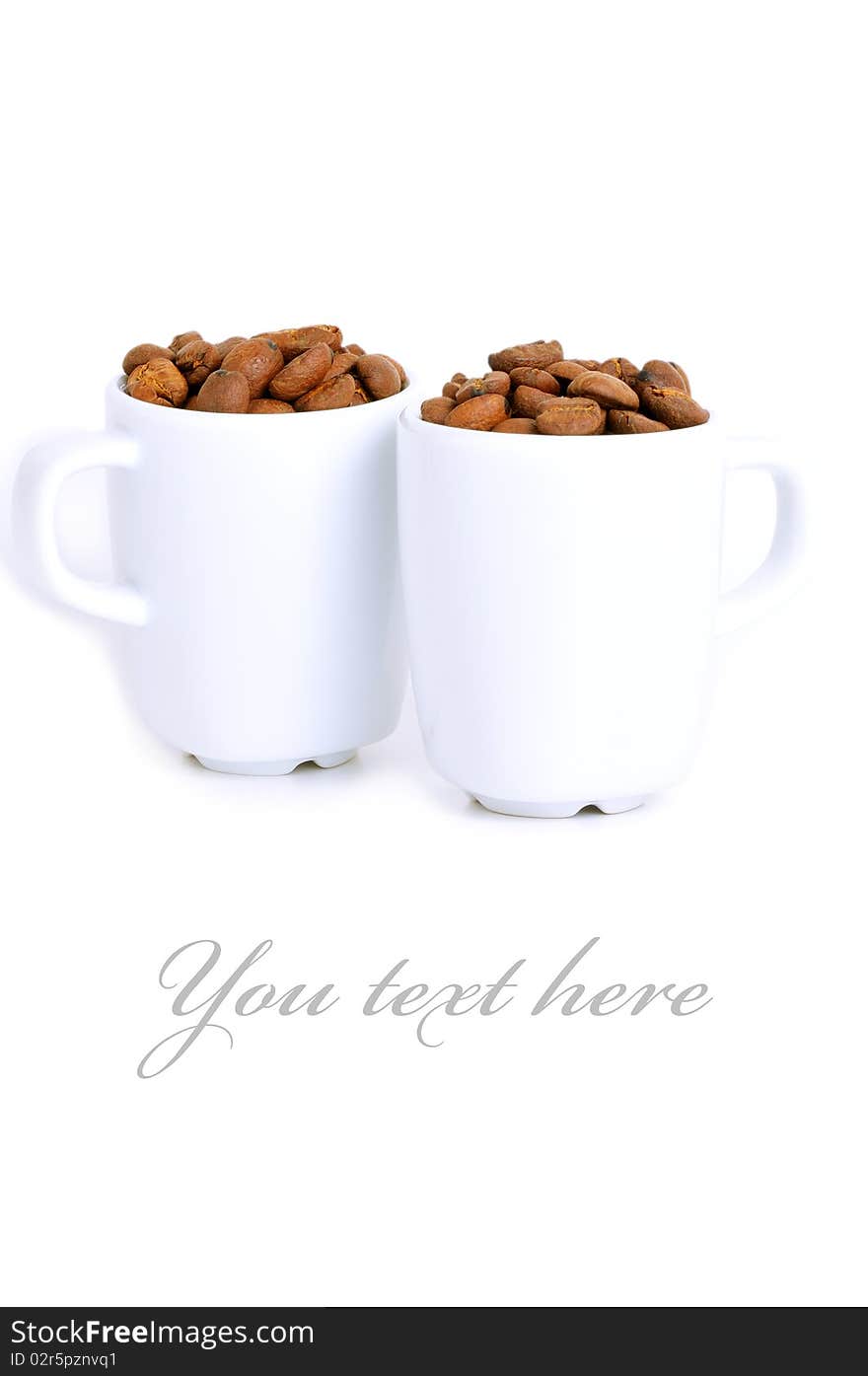 Couple of cups filled with roasted coffee beans. Couple of cups filled with roasted coffee beans