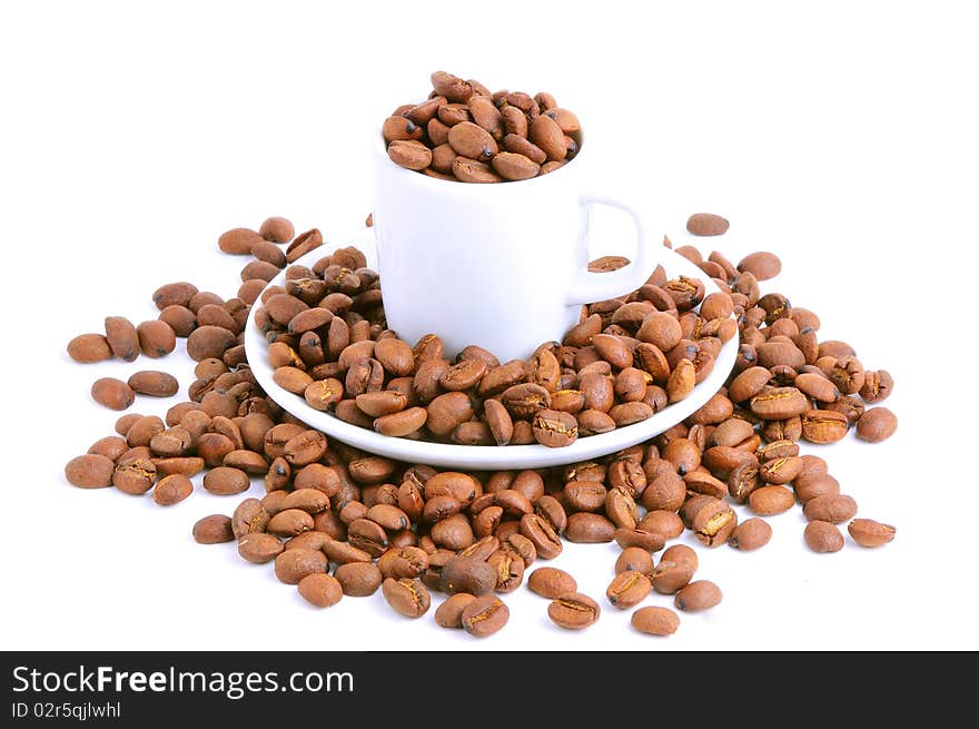 Coffee cup filled with coffee beans isolated