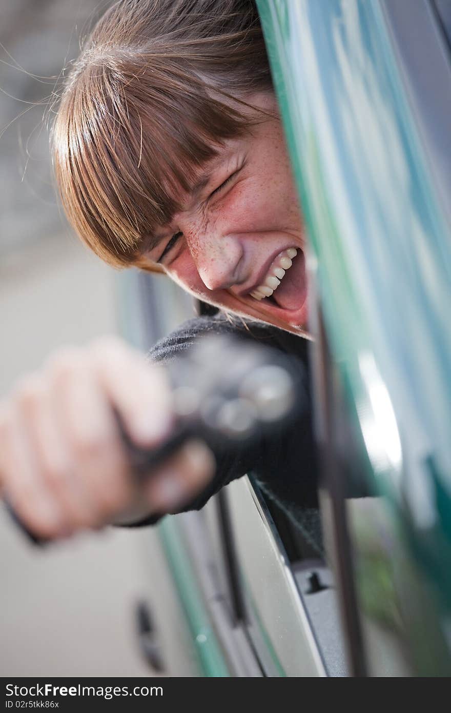 Screaming woman shooting from a driving car. Screaming woman shooting from a driving car