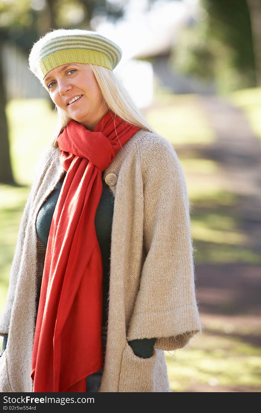 Portrait Of Woman Outdoors In Autumn Landscape Smiling At Camera