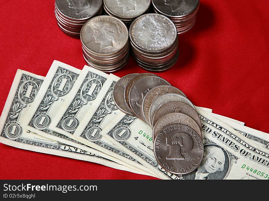 Great money image featuring antique silver dollars from various years along with current paper currency. Great money image featuring antique silver dollars from various years along with current paper currency