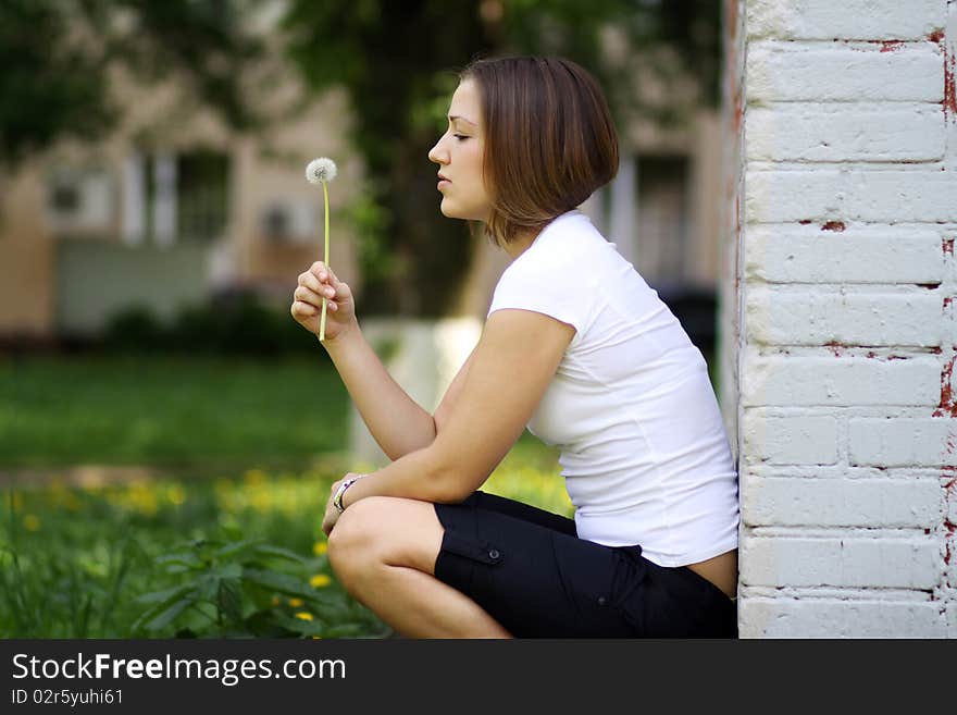 Dandelion - The girl blows on a dandelion