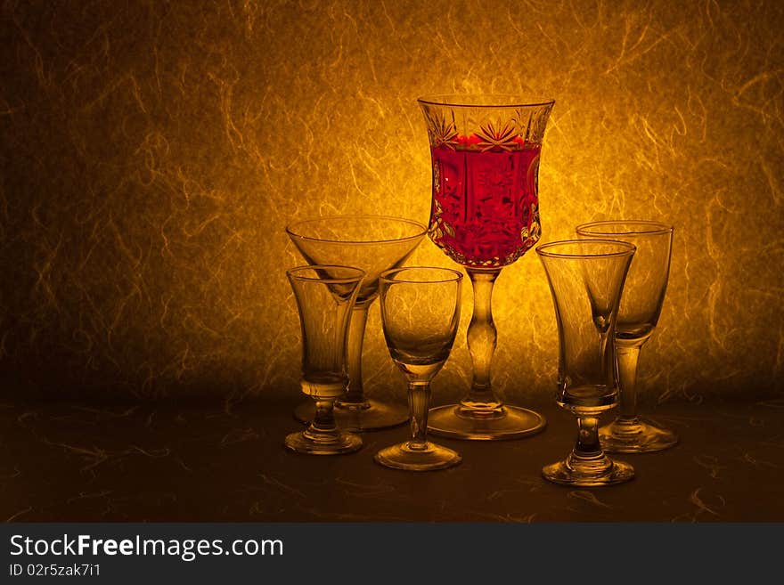 Red wine and glass on brown background