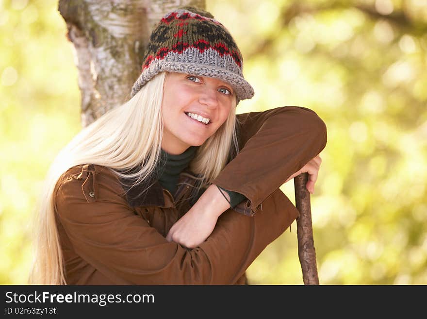 Young Woman Outdoors Walking In Autumn Woodland