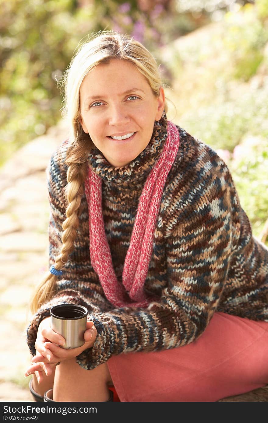 Young Woman Relaxing With Thermos Flask