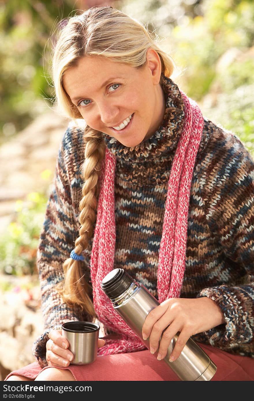 Young Woman Relaxing With Thermos Flask