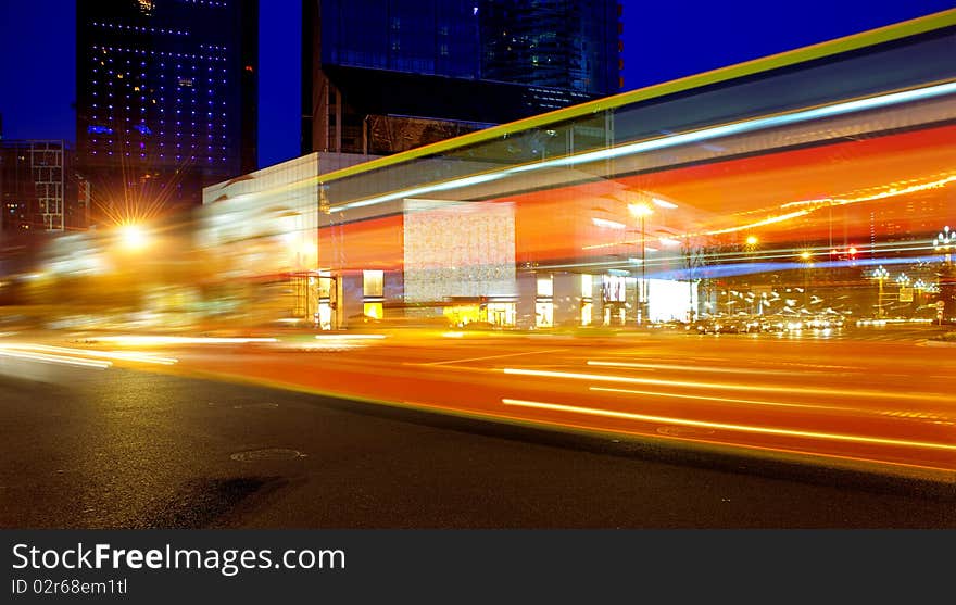 High speed and blurred bus light trails in downtown nightscape