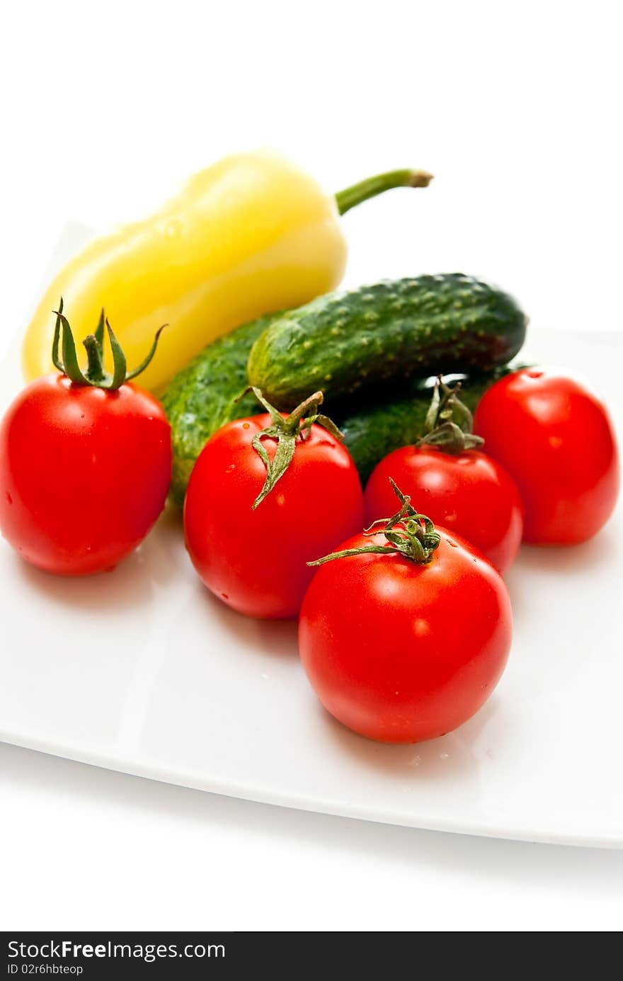 Tomato, cucumber and pepper in plate on white background. Tomato, cucumber and pepper in plate on white background