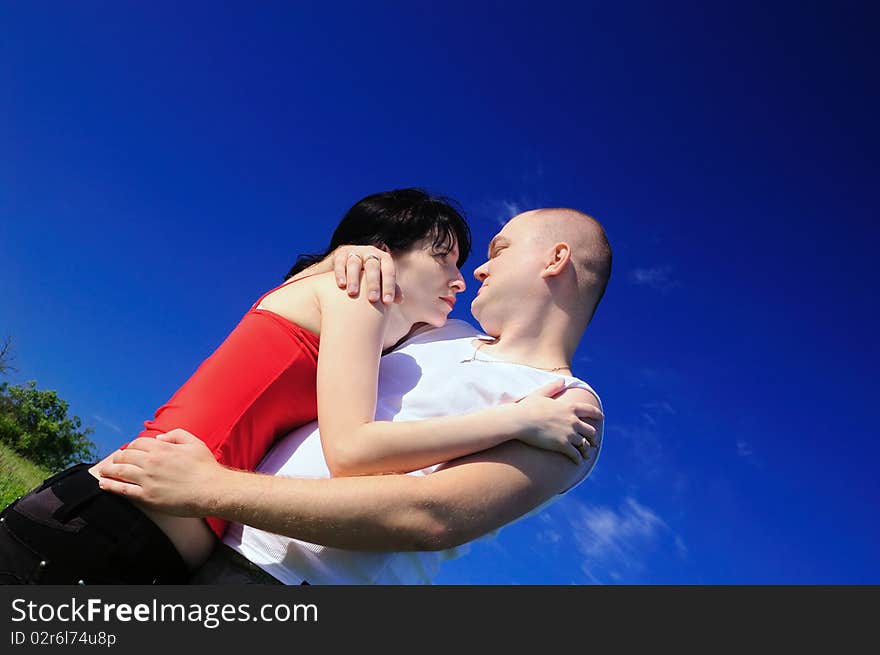 Enamoured pair on sky background