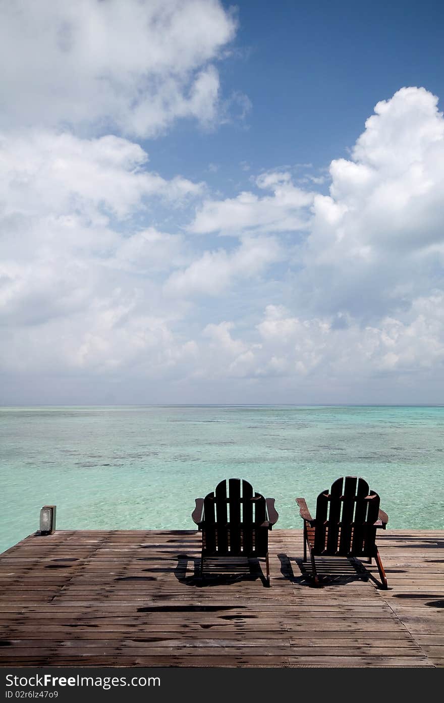 A pair of chair in front of beach. A pair of chair in front of beach