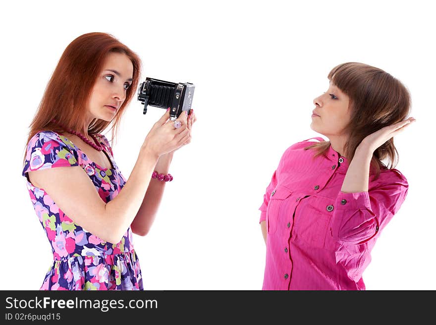 Two beautiful girls to pose and take pictures on white background