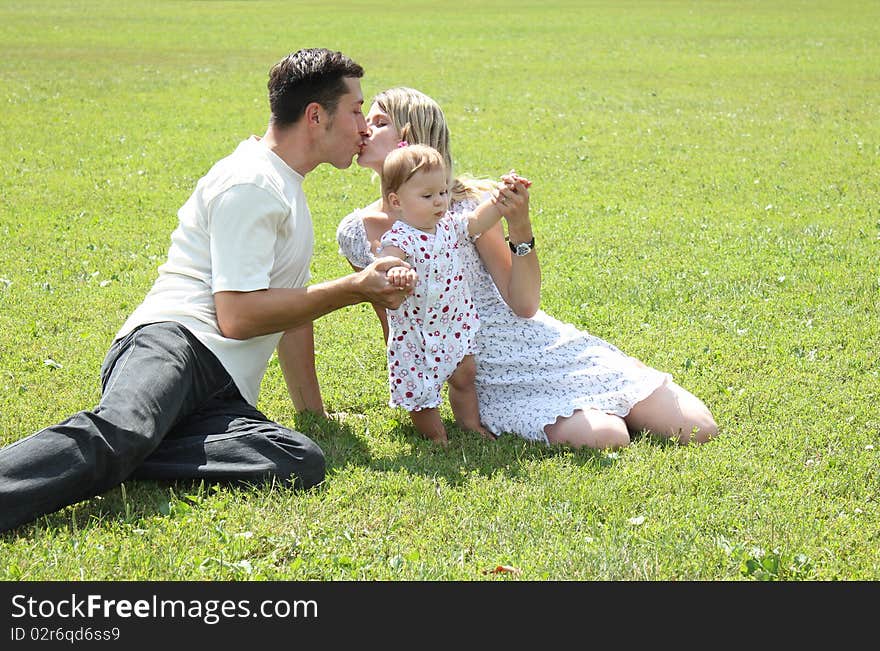 Happy family on the green grass